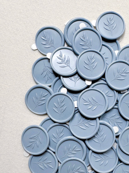 Dusty blue wax seals featuring a leaf branch design with 3D engravings