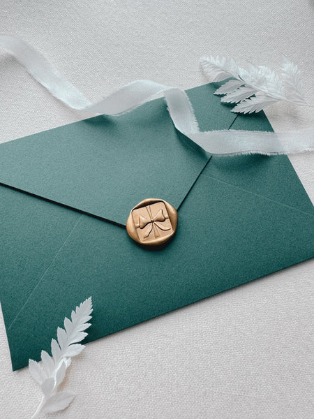 3D festive ribbon bow wax seal on Christmas card envelope