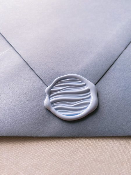3D waves wax seal in pale blue on blue paper envelope