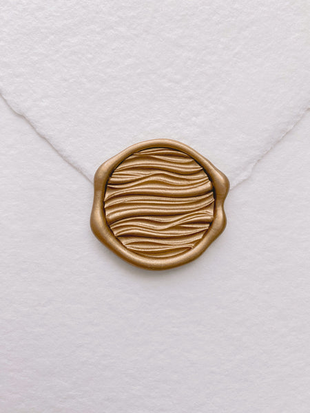3D waves wax seal in gold on beige handmade paper envelope