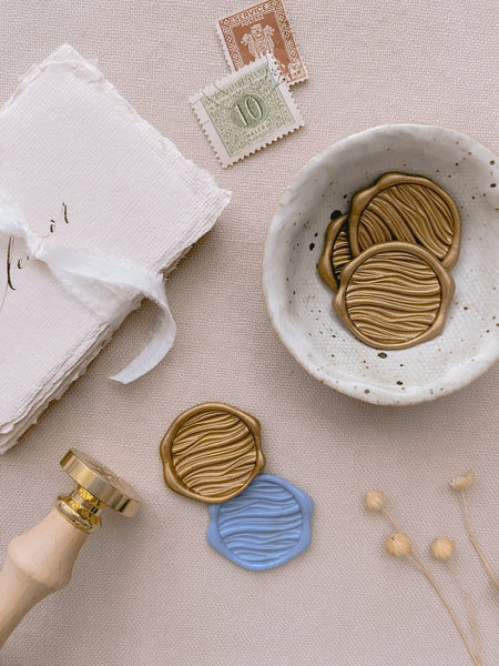 Dusty blue and gold 3D ocean waves wax seals