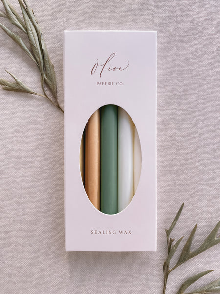 a box of 5 glue gun sealing wax sticks in color gold, peachy gold, sage green, white pearl, and off-white