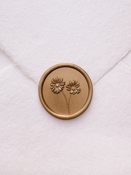 gold daisies flower bouquet wax seal on a white envelope