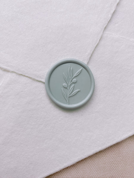 Olive branch wax seal in eucalyptus color on white handmade paper envelope