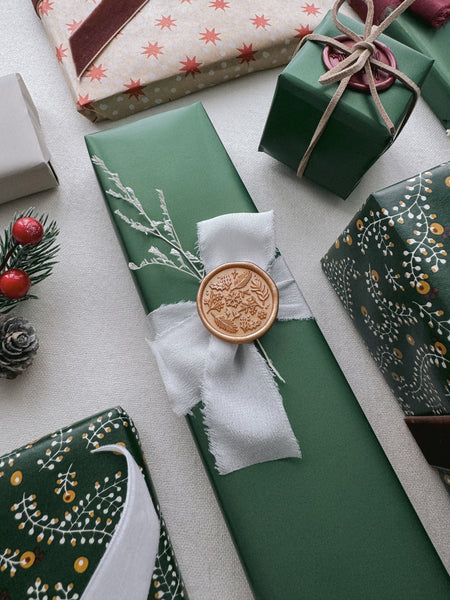 festive Christmas ornament design wax seal on holiday gift wrap