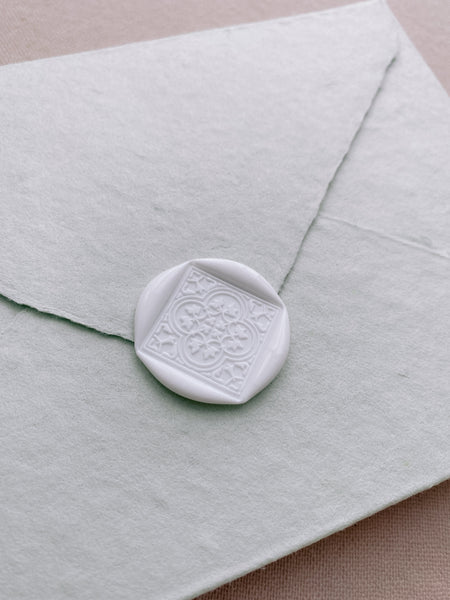 Moroccan tile quatrefoil pattern wax seal in off-white on beige handmade paper envelope