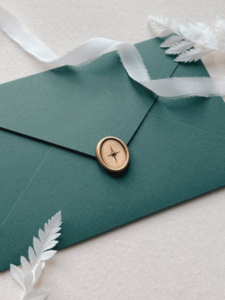 Dark green envelope with gold North Star mini oval wax seal