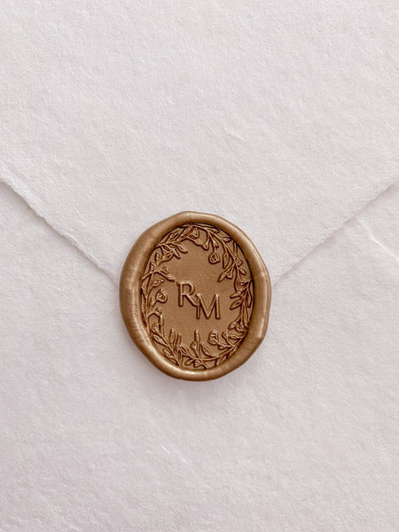 Oval floral crown monogram gold custom wax seal on beige handmade paper envelope 