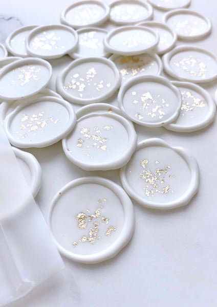 a bundle of gold leaf white wax seals