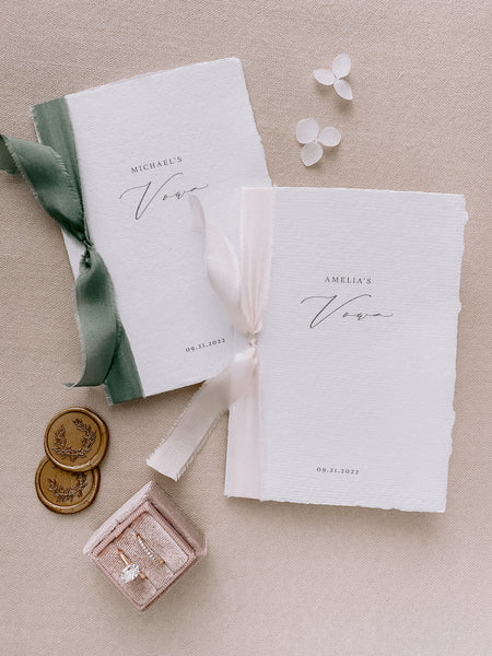 personalized white handmade paper vow books with green and pink silk ribbons