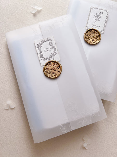 vow books packaged in floral print vellum jacket, gold wax seal and letterpress postage stamp