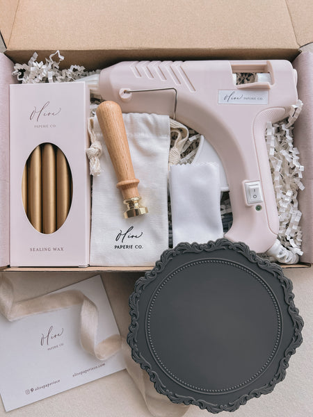 custom wax seal stamp kit containing wax stamp, sealing wax, glue gun and other wax seal supplies