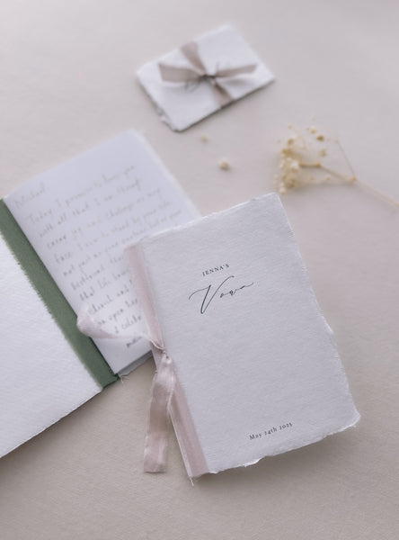white handmade paper wedding vow books with personalized names and date