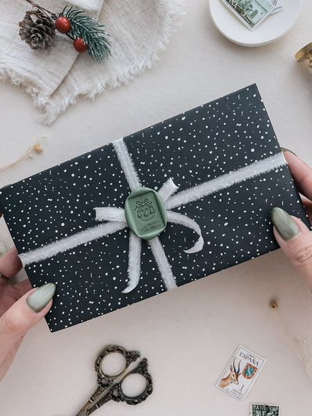 Green festive ornaments Merry Christmas rectangular wax seal on a wrapped gift