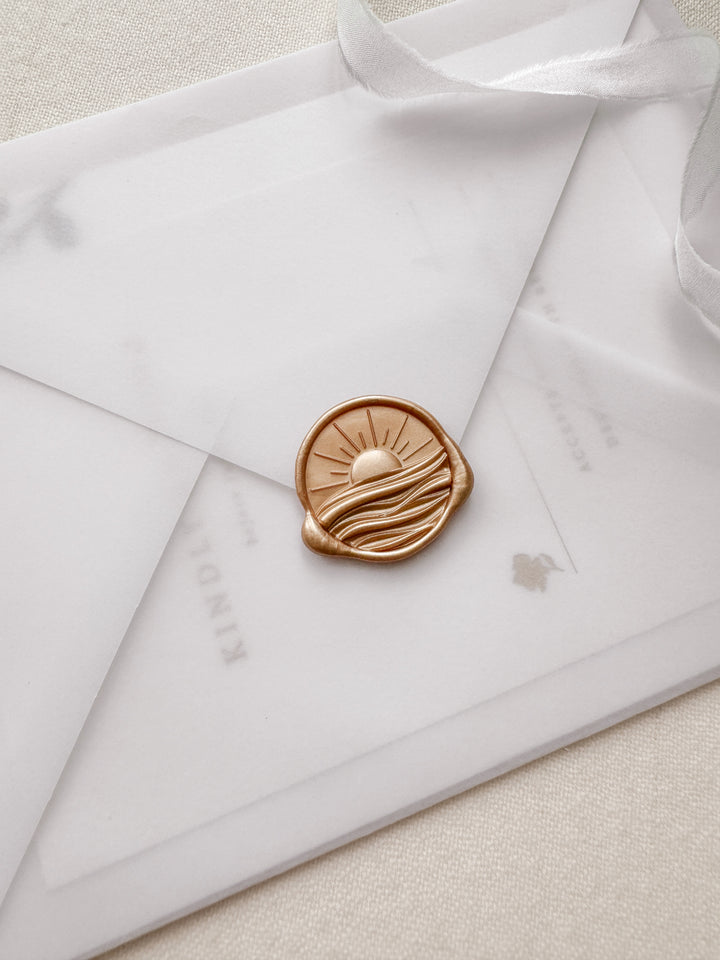 Orange gold 3D sun ray over ocean waves wax seal on a vellum wedding invitation envelope 