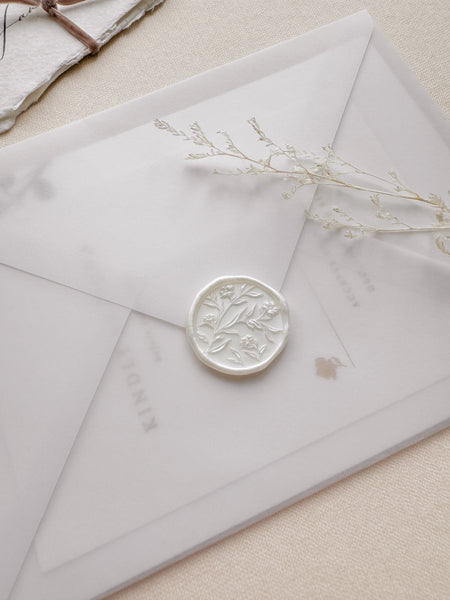 Pearl white floral pattern wax seal with 3D engraving on a vellum envelope