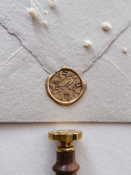 gold flower design wax seal with 3D engraving on beige handmade paper envelope