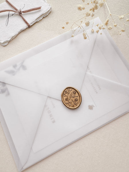 Oval floral pattern gold wax seal with 3D engraving on a vellum envelope