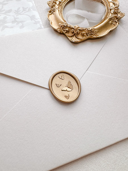 Butterflies wax seal with 3D engravings in color light gold on a light beige envelope