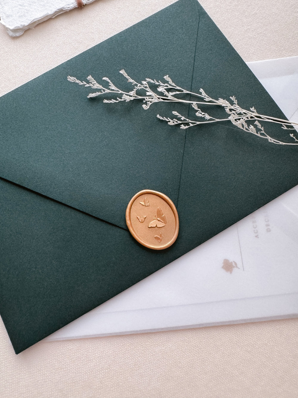 peachy gold 3D butterflies wax seal on dark green envelope