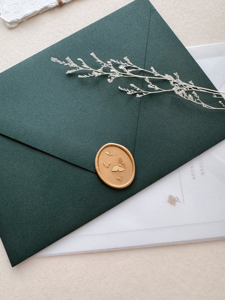 Orange gold 3D oval butterflies wax seal on a dark green envelope