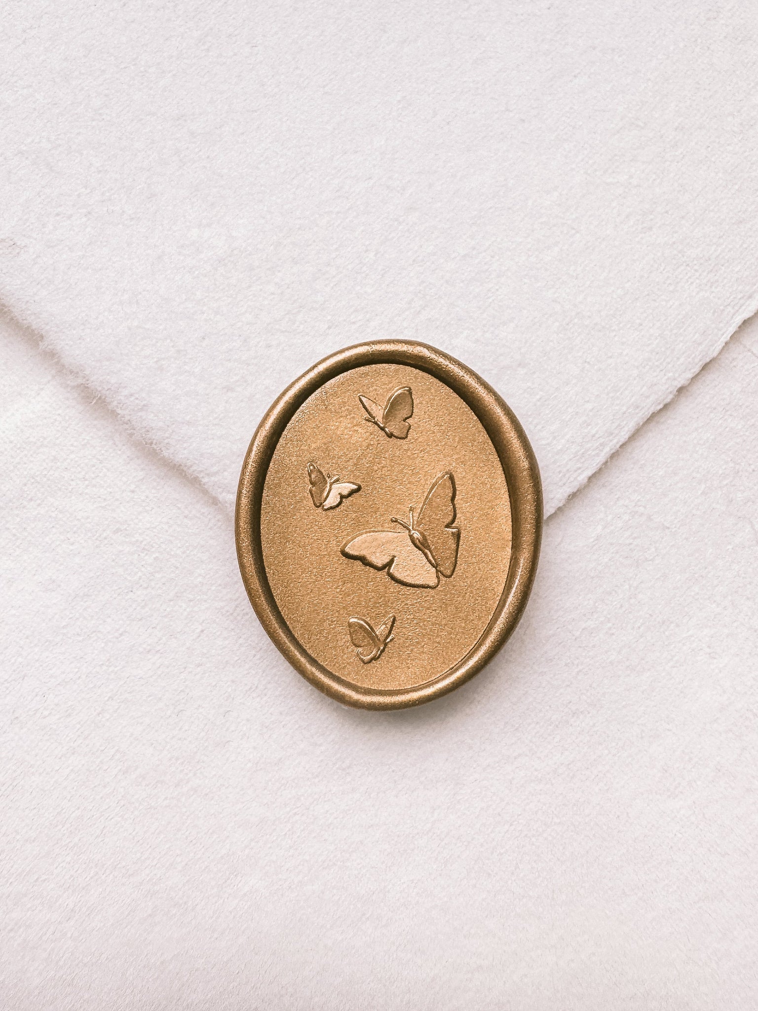 Butterflies gold wax seal with 3D engravings on a white handmade paper envelope