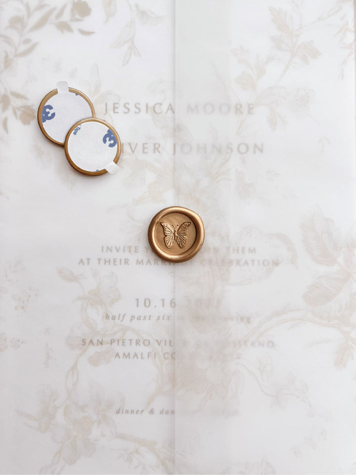 3D butterfly mini gold wax seal stickers with self-adhesive backings on a beige floral vellum jacket