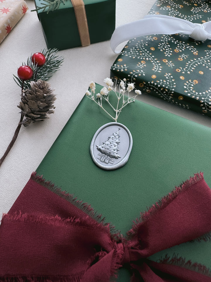 silver 3D Christmas tree wax seal decorated on a Christmas gift