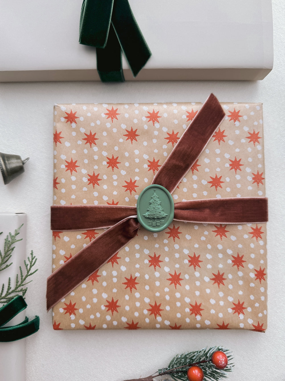 green 3D Christmas tree wax seal on festive gift wrap