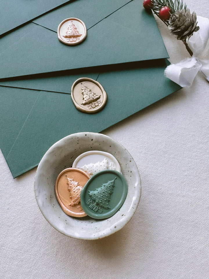 holiday card envelopes with Christmas tree wax seal stickers with intricate 3D engraving