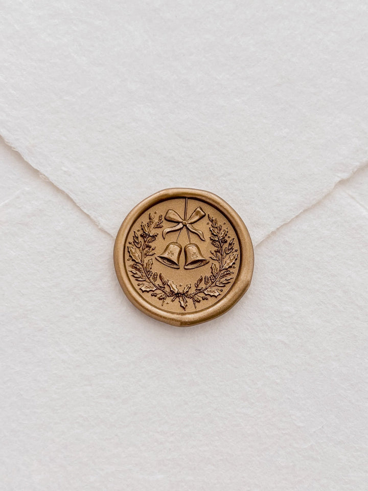gold 3D Christmas wreath wax seal on a white envelope