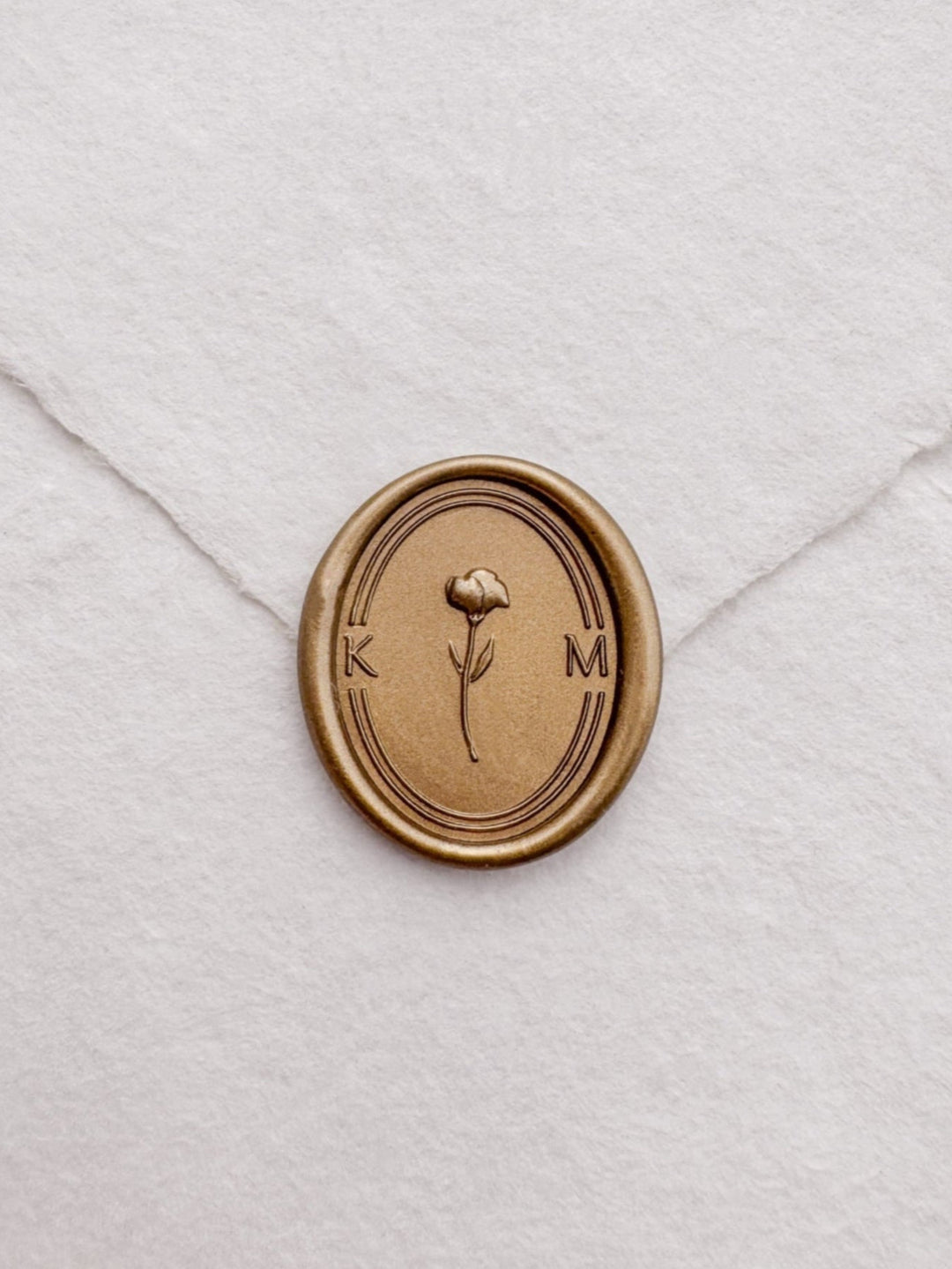 custom initials gold wax seal with a 3D flower design