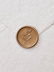 Leaf branch gold wax seal with 3D engraving details on a white handmade paper envelope