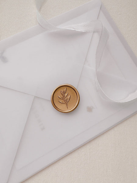 Leaf branch gold wax seal with 3D engraving details on a vellum envelope 