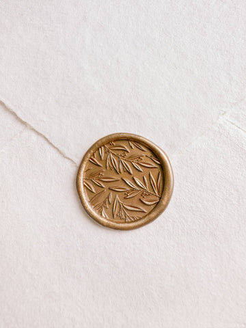 Leaf pattern gold wax seal with 3D engraving details on a white handmade paper envelope