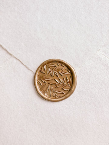 Leaf pattern gold wax seal with 3D engraving details on a white handmade paper envelope