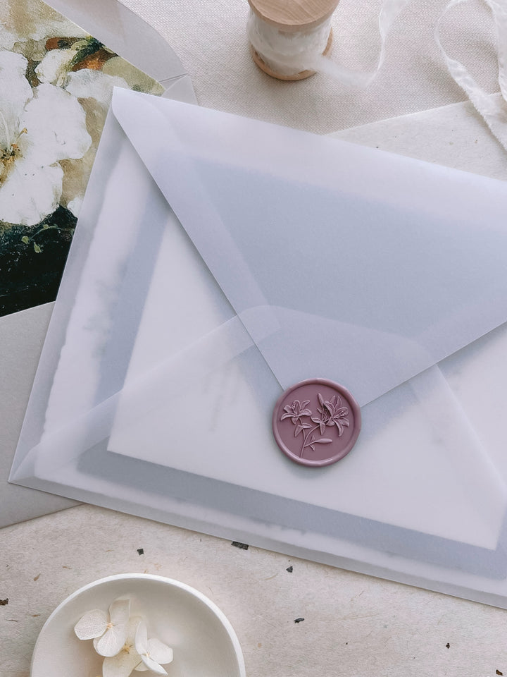 Mauve lilies floral wax seal with 3D engraving on a vellum wedding invitation envelope