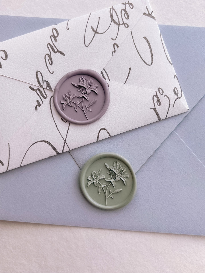 Lavender purple and light sage green 3D lily flowers wax seals on a light blue envelope and a mini white envelope 