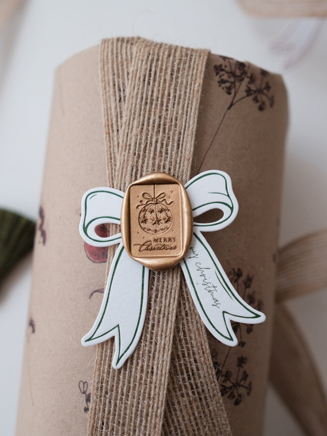 Festive ornament Merry Christmas wax seal on a wrapped Christmas gift