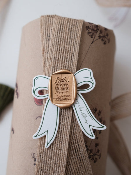 Festive ornament Merry Christmas wax seal on a wrapped Christmas gift