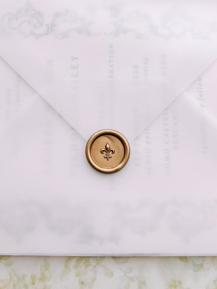 Gold mini 3D fleur de lis wax seal on a vellum wedding inivitation envelope