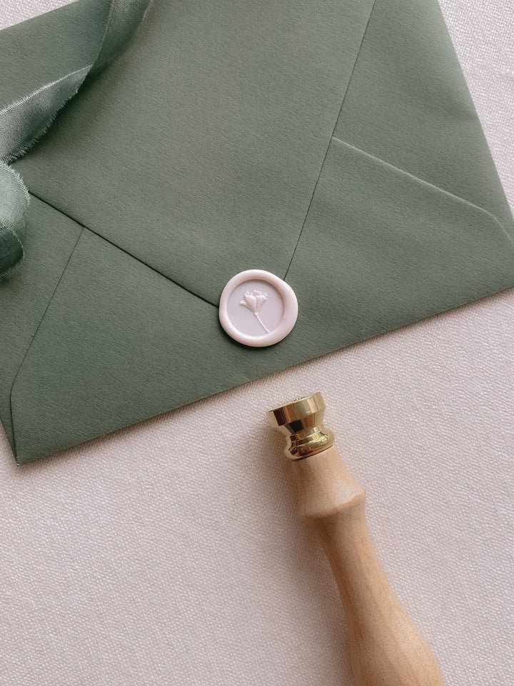 Mini flower wax seal with 3D engraving on olive green paper envelope styled with wax seal stamp
