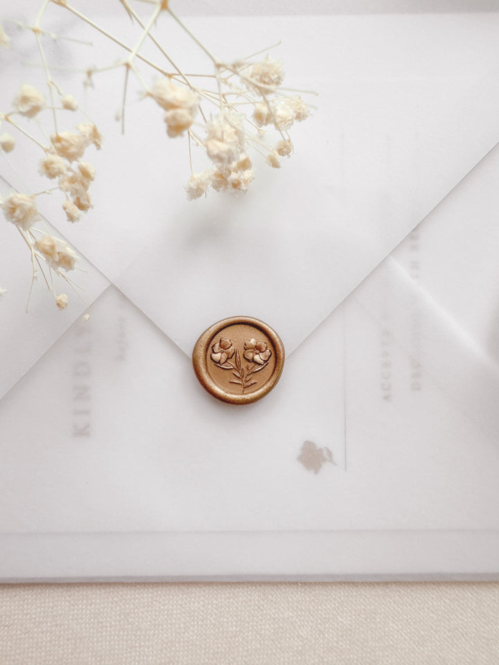 peachy gold mini gardenia flower wax seal on a vellum wedding invitation envelope 