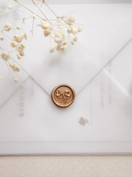 Mini gold wax seal featuring gardenia flowers with 3D engravings on a vellum envelope