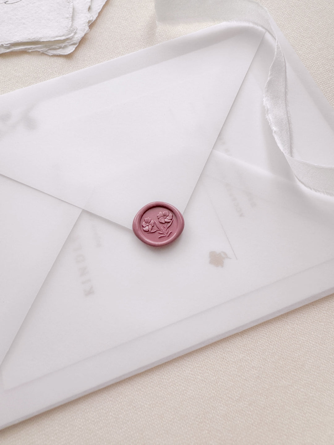 rose pink 3D mini gardenia floral wax seal on a vellum wedding invitation envelope 