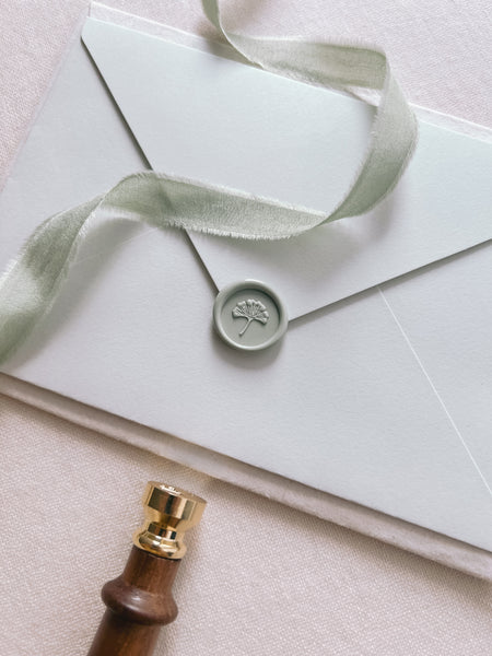  Light pastel green ginkgo leaf mini wax seal on a light green envelope