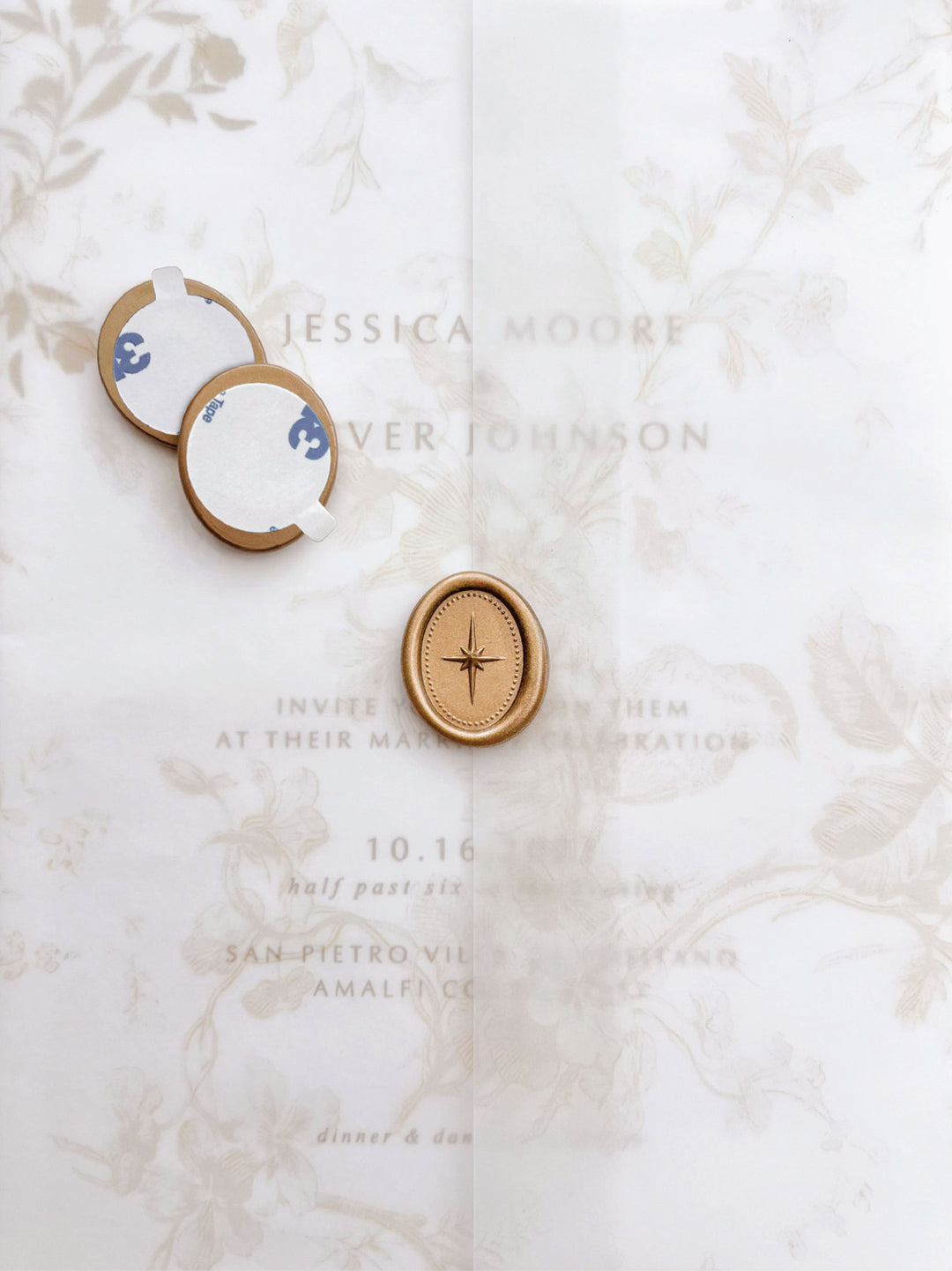 Gold 3D North star mini oval gold wax seal stickers with self-adhesive backings on a beige floral vellum jacket