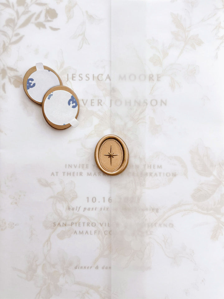 Gold 3D North star mini oval gold wax seal stickers with self-adhesive backings on a beige floral vellum jacket