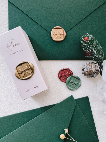 Christmas envelope stamp and festive wax seals featuring ribbon bow design with 3D engraving