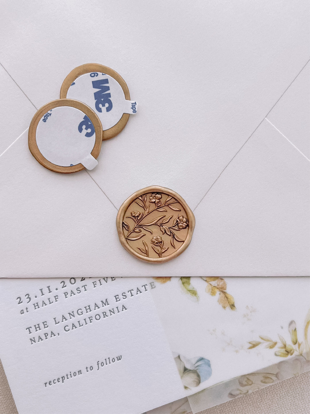 3D florals gold wax seal stickers with self-adhesive backings on a wedding invitation, beige envelope, and floral vellum jacket